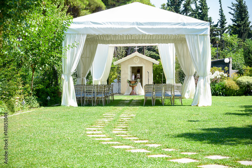 Decorative place for ceremonies or entertainments. Outdoor reception under tents and trees
