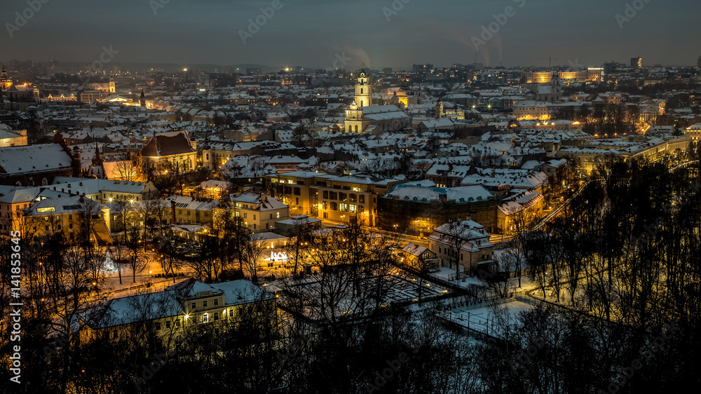 Aerial panorama of the Vilnius Old Town at dusk time. Night panorama of the Vilnius Old Town from the Hill of Three Crosses, Lithuania. Vilnius winter aerial panorama of Old town.