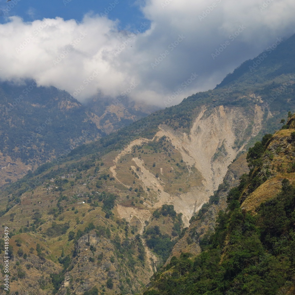 Small village situated close to a big landslide. Scene near Jagat, Annapurna Conservation Area, Nepal.