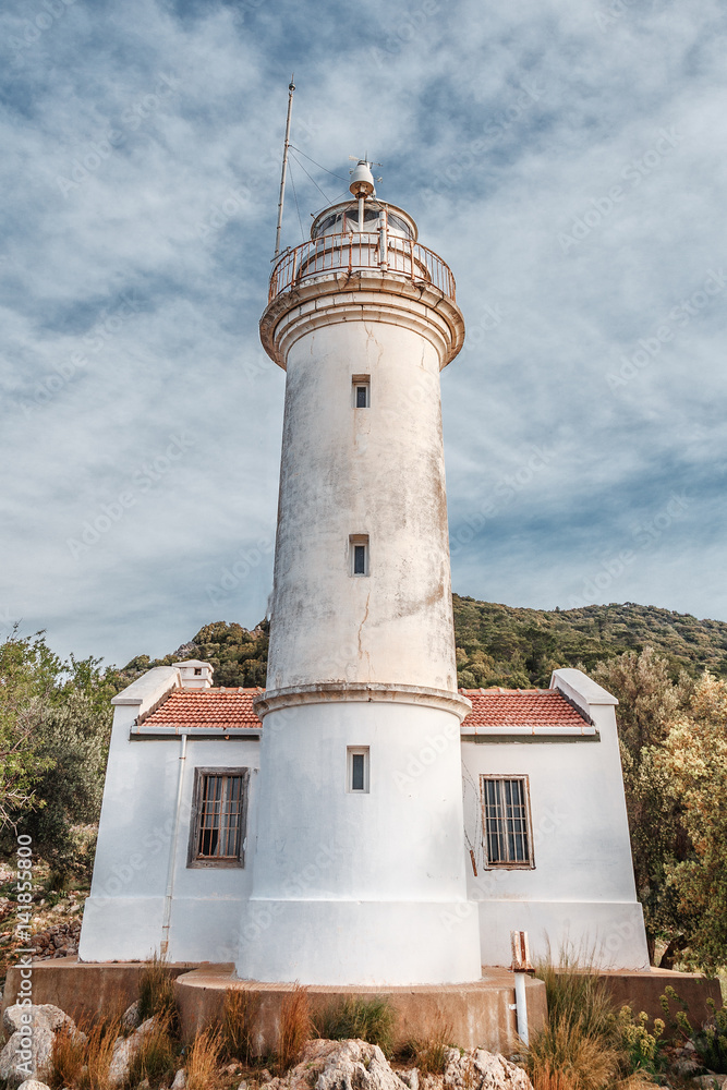 Lighthouse at Gelidonya cape, coastline of Mediterranean sea, Turkey. Location nearby Kanaoz, Kemer and Antalya turkish resort city. Famous travel destination. Vertical orientation.