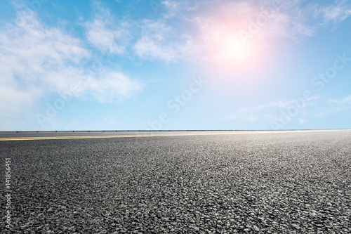 Asphalt road and blue sky © ABCDstock