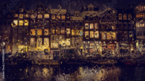 Amsterdam houses view through the glass with raindrops