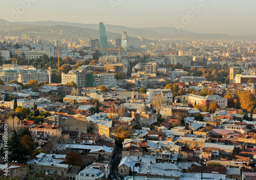 View to Mtatsminda distric of the Tbilisi of Republic of Georgia. View of the Freedom Square, high Biltmor Hotel and other buildings. photo