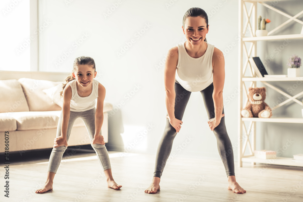 Mom and daughter doing yoga Mom and daughter doing yoga