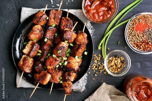 Bbq meat on wooden skewers on plate