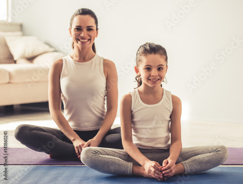 Mom and daughter doing yoga