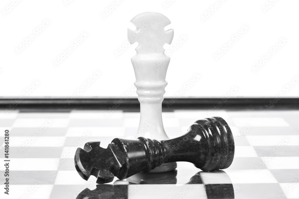 Black and white chessmen on chessboard Black and white chessmen on chessboard