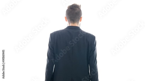 Arrogant bearded man in suit rude gesturing and turning around, studio isolated on white background.