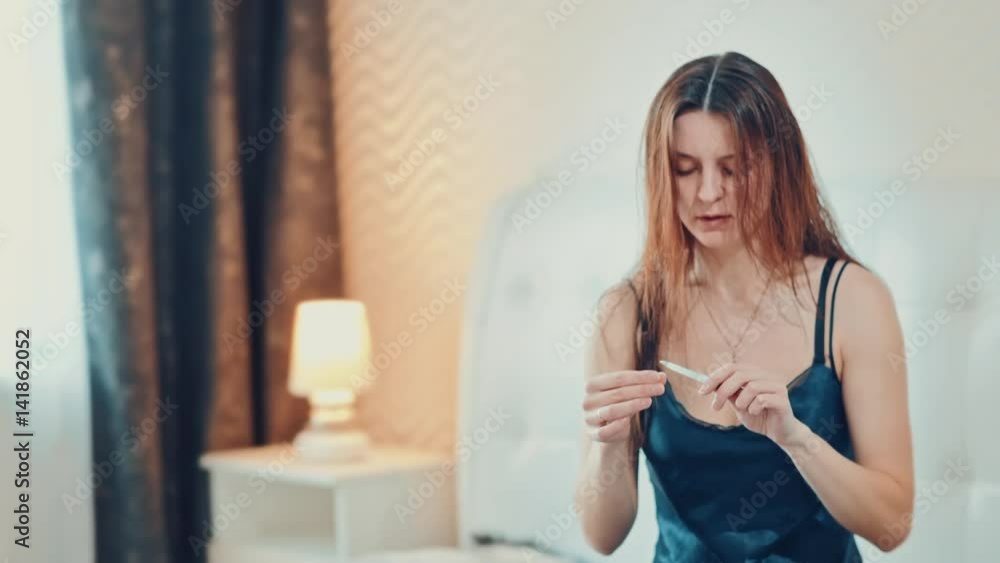 beautiful in bedroom girl doing manicure. Slow motion. beautiful in bedroom girl doing manicure. Slow motion.