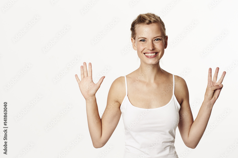 Gorgeous woman smiling and holding up fingers Gorgeous woman smiling and holding up fingers