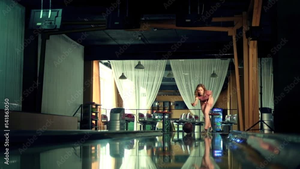 Young woman is throwing ball in a bowling club Slow motion Young woman is throwing ball in a bowling club Slow motion