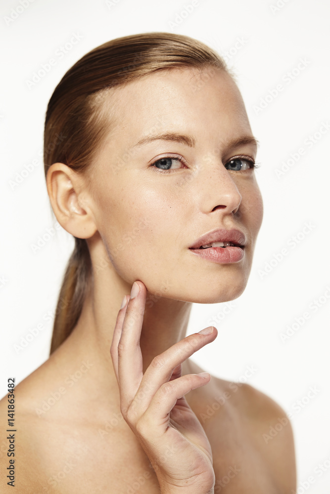 Beautiful woman touching perfect skin, portrait