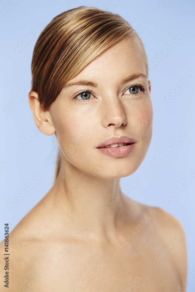 Blue eyed beautiful woman against blue background Blue eyed beautiful woman against blue background