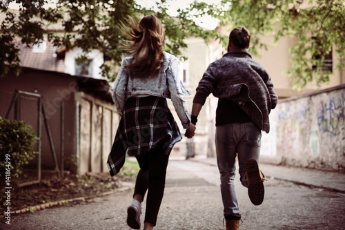 Happy couple running outdoor.