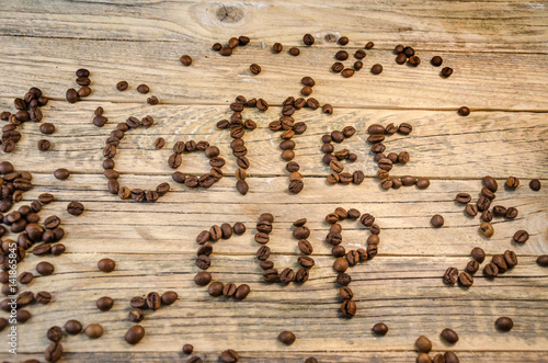 Coffee cup. Roasted Coffee beans on natural wooden background