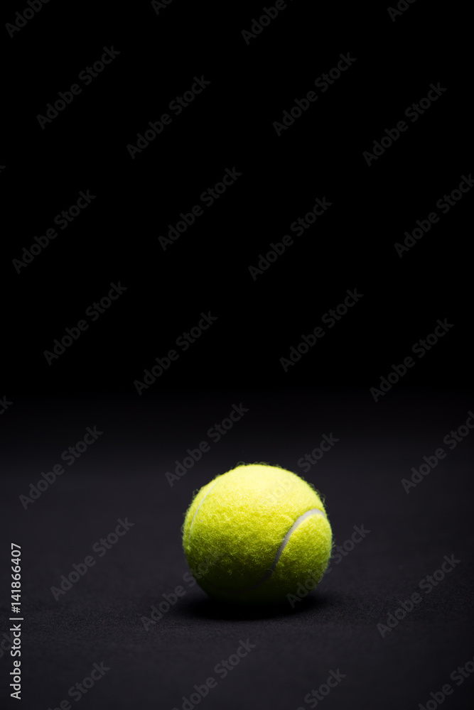 Tennis ball on black