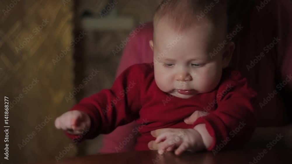Tapping Baby Boy in Red on Mother's Laps Tapping Baby Boy in Red on Mother's Laps