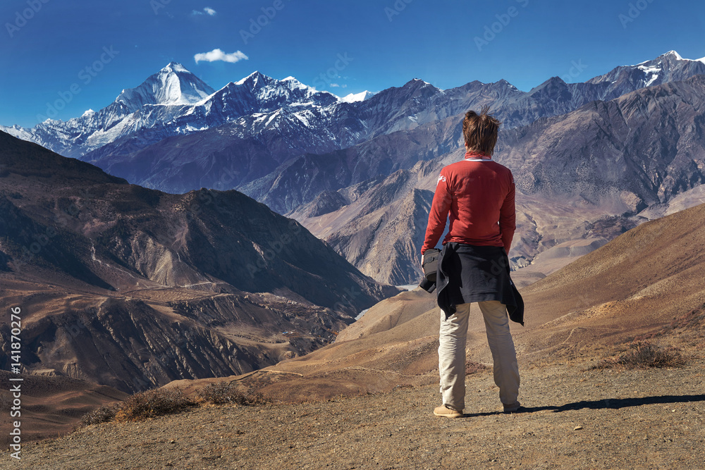 Man standing and watching at the Dhaulagiri mountain peak in Himalayas, Nepal