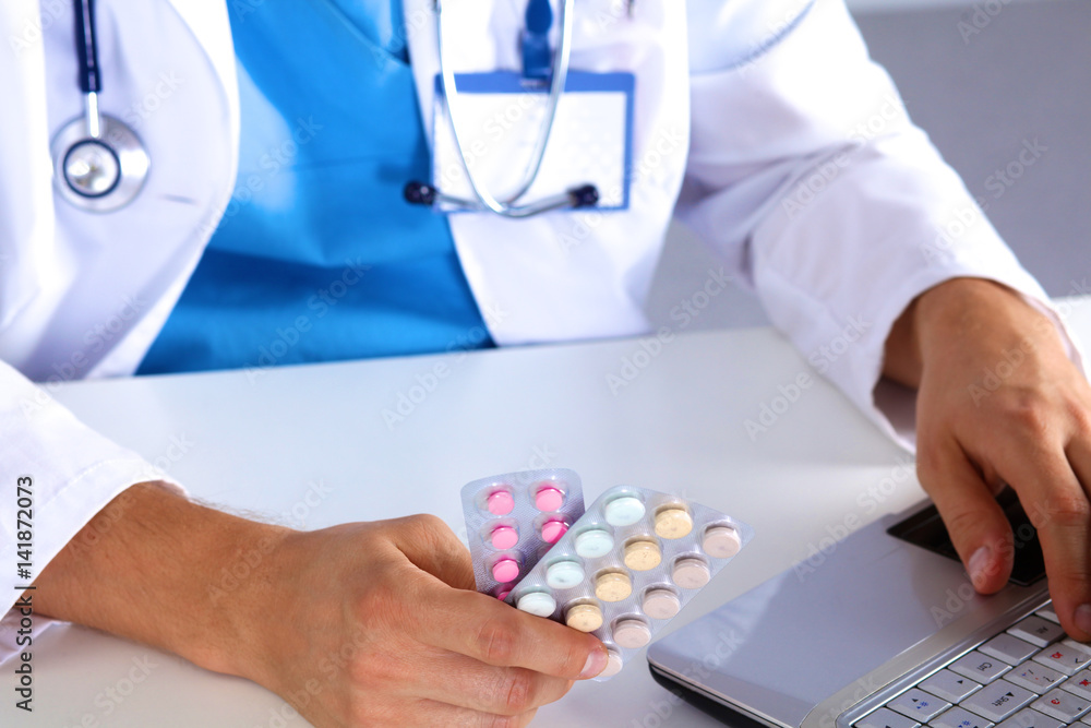 young doctor holds the patient's hand with pills young doctor holds the patient's hand with pills