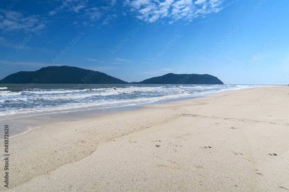 Beautiful white beach with mountains in the background Beautiful white beach with mountains in the background