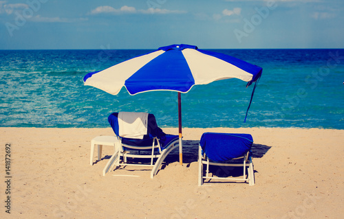 Two chairs on sand beach