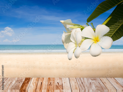 Summer beach concept background with plumeria flower and wood plank