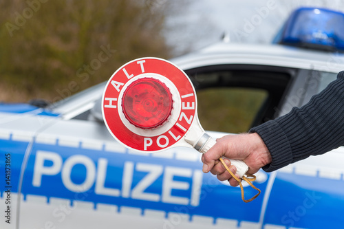 Polizeikontrolle - Polizist mit Polizeikelle photo