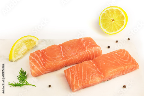 Two slices of salmon on white background with copyspace