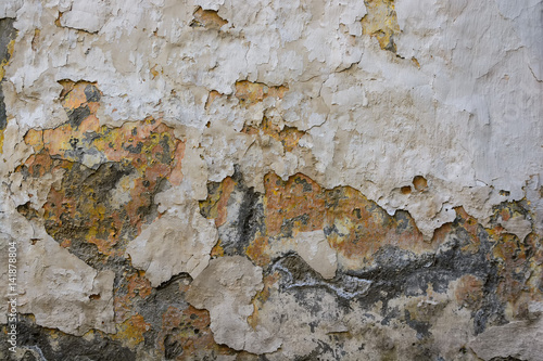 Texture of grey cement plaster with cracked paint