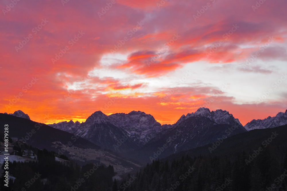 Red scenic sunset over the Dolomites of Comelico