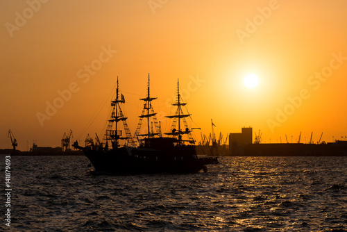 Ship at sunset. Tourist boat in the sea in the rays of the setting sun © NatBud