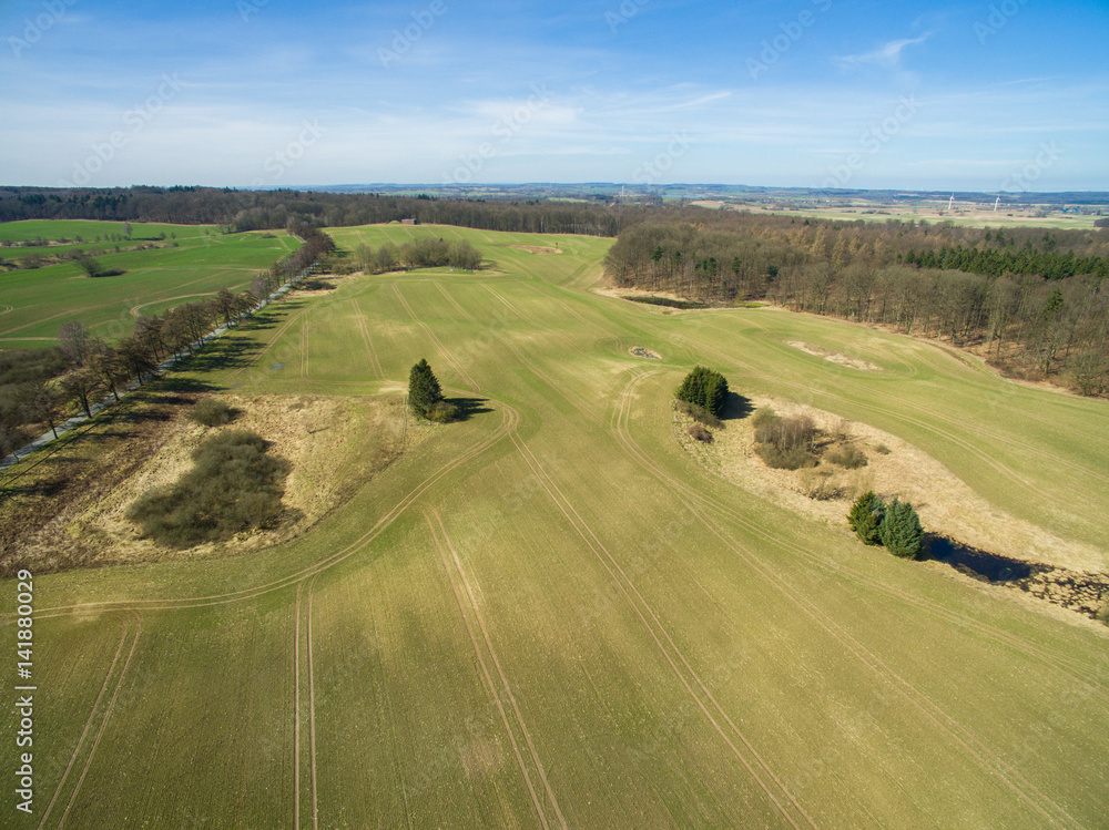 Aerial view of a green rural area agricultural fields under blue sky in germany