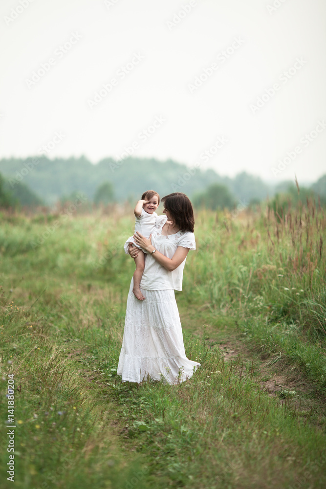 happy young mother with little daughter in arms happy young mother with little daughter in arms