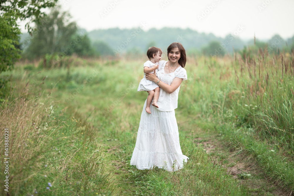 happy young mother  with little daughter in arms