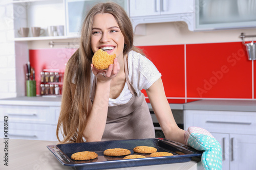 Young woman with cookies on...