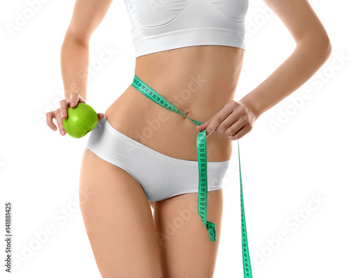 Woman with measuring tape and apple isolated on white