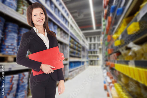 Young happy smiiling businesswoman doing apprenticeship in a supermarket photo