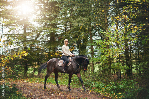 Woman training on a horse in the park © Flamingo Images