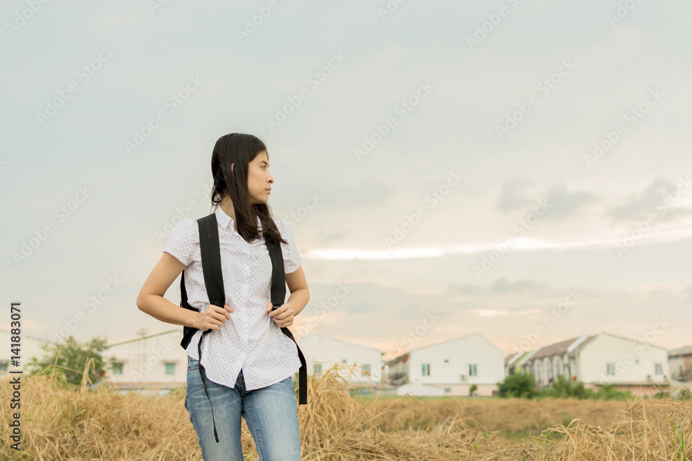 young traveler woman walking along country road. young traveler woman walking along country road.