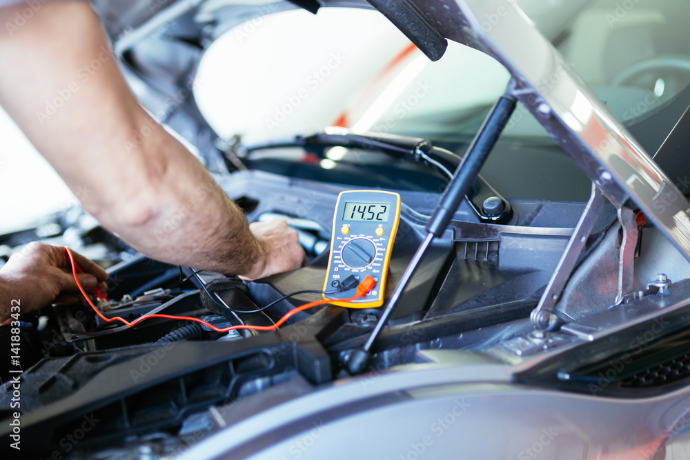 Auto mechanic repairing car. Selective focus on hand. Auto mechanic repairing car. Selective focus on hand.