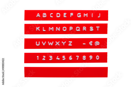 Fotografija embossed alphabet on red plastic tape, isolated on white