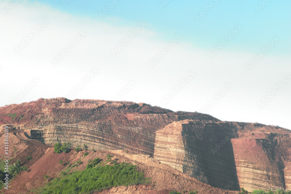 Mountain cliff of red brown colored chinese soil agriculture landscape in the morning.