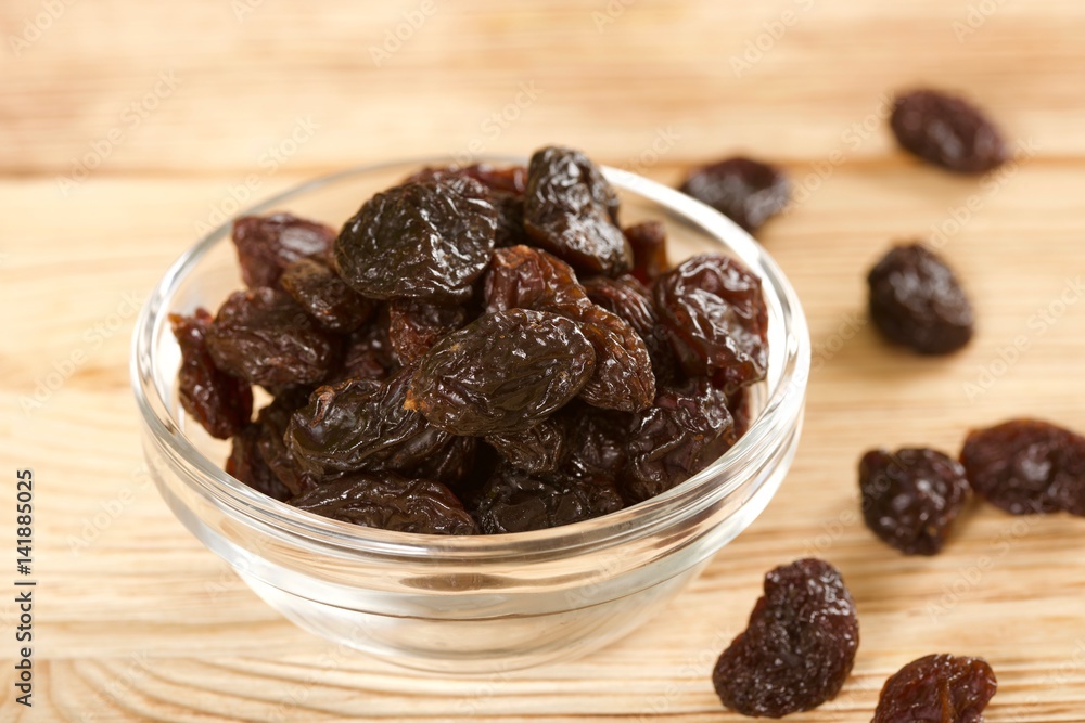 raisins on a wooden background raisins on a wooden background
