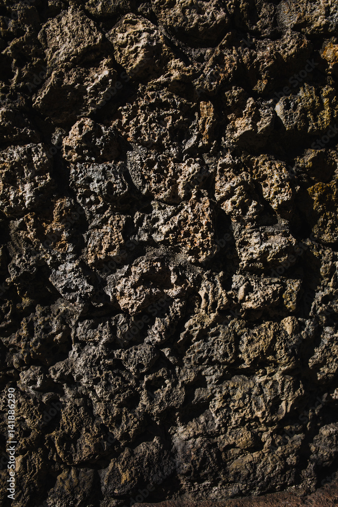 Black and brown decorative texture plaster on the wall outdoors