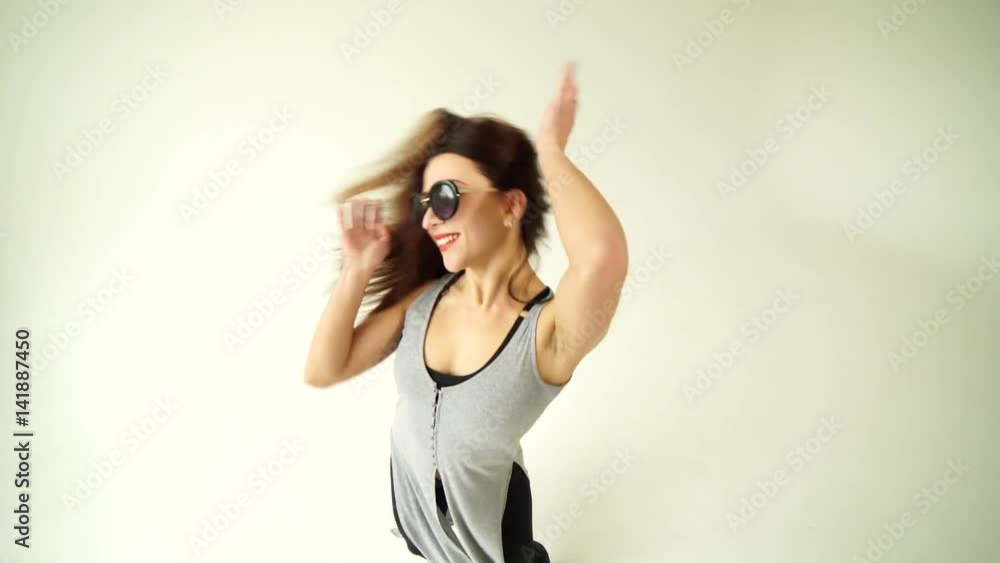 Young woman dancing against a white background at studio 4K Young woman dancing against a white background at studio 4K