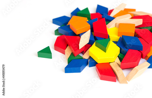 Multicolored pattern blocks on a white wooden background.Isolate.  photo
