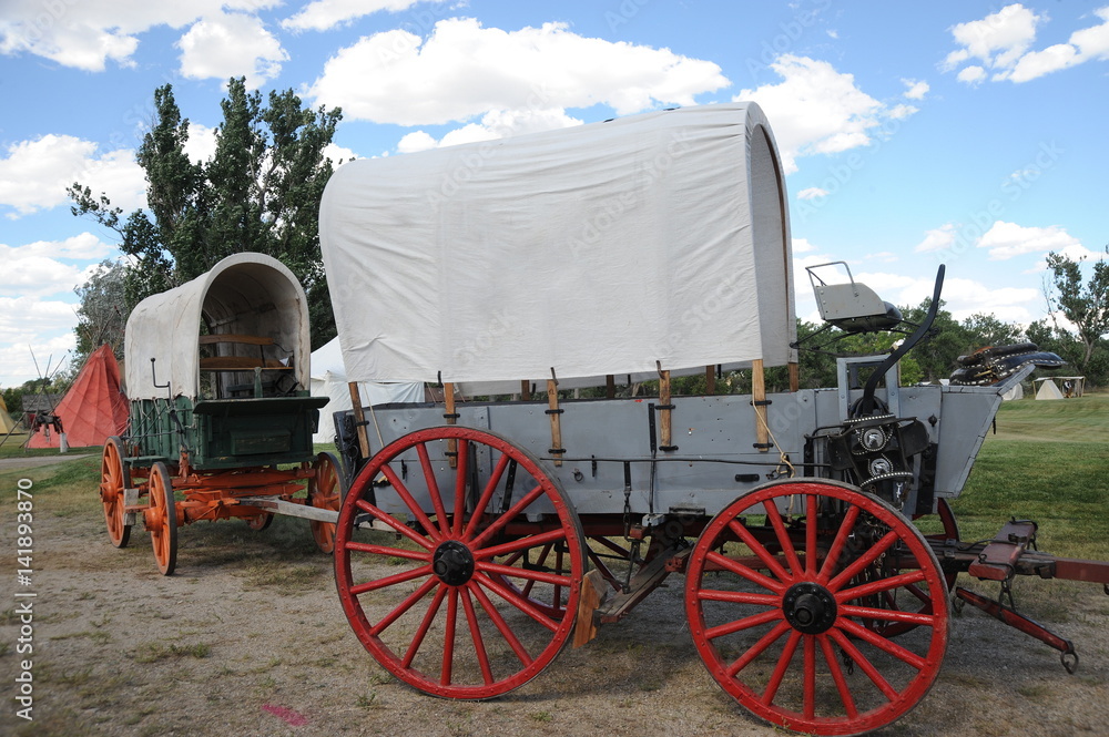 Pioneer covered wagon displayed outdoors.