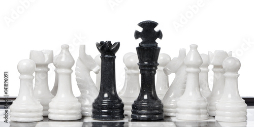 Black king and queen and white chessmen on chessboard