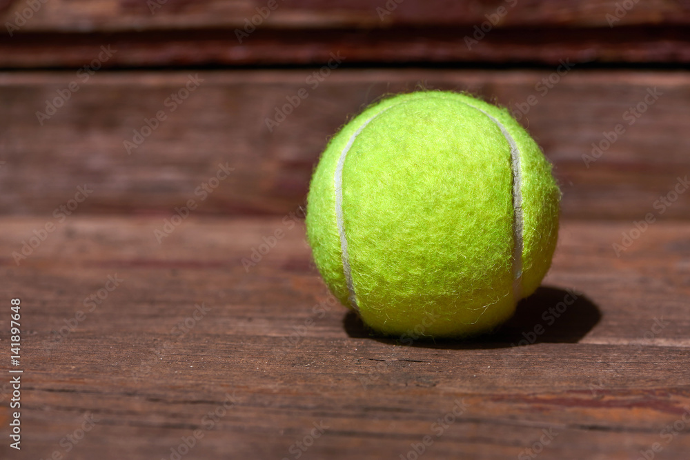 Tennis ball on wooden background