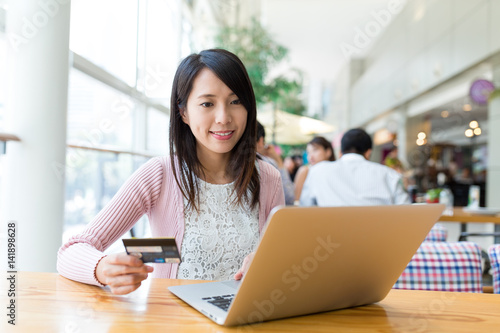 Woman using credit card for online shopping